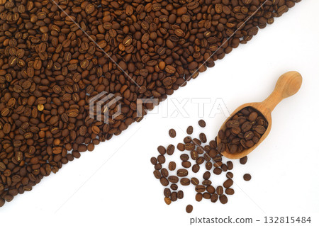 Coffee beans in a wooden scoop isolated on a white background. Roasted coffee beans isolated 132815484