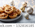 Festive arrangement of mince pies and holiday ornaments on gray stone background. Copy space 132816185