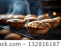 Freshly baked mince pies cooling on a wire rack, steam rising 132816187
