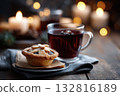 Christmas mince pies on a wooden table decorated with holly leaves and cinnamon sticks 132816189