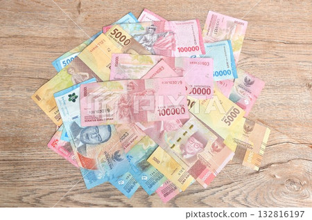 indonesia rupiah banknote arranging on wooden table texture and background indonesia rupiah banknote arranging on wooden table texture and background 132816197