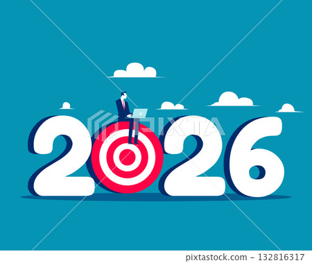 2026. Businessman using laptop sitting on archery target 2026 132816317