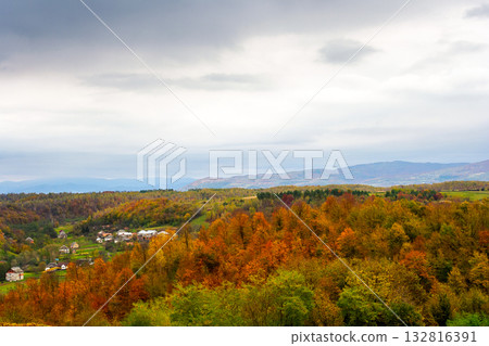 autumn landscape in mountains with village in the valley. overcast morning sky over carpathian countryside in fall season. beautiful location with colorful forest autumn landscape in mountains with village in the valley. overcast morning sky over carpathian countryside in fall season. beautiful location with colorful forest 132816391