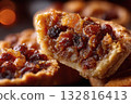 Close-up of mince pie filling, rich dried fruits and spices, broken crust revealing texture 132816413