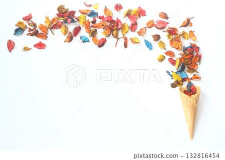 Top view of ice cream cone with colorful flower on the white background Top view of ice cream cone with colorful flower on the white background 132816454