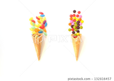 Top view of ice cream cone with colorful candy on the white background Top view of ice cream cone with colorful candy on the white background 132816457