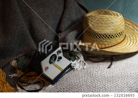 Travel preparations with straw hat and vintage instant camera. Horizontal shot. Copy space Travel preparations with straw hat and vintage instant camera. Horizontal shot. Copy space 132816693