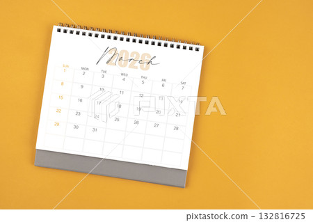 Top view of March 2026 desk calendar on yellow color background. Top view of March 2026 desk calendar on yellow color background. 132816725
