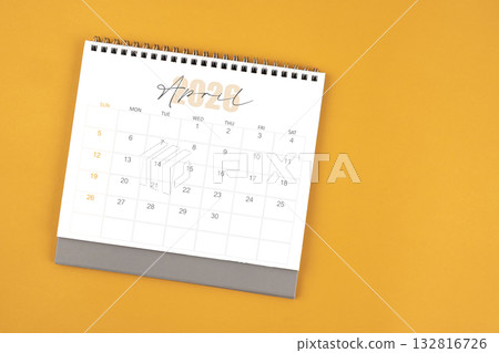 Top view of April 2026 desk calendar on yellow color background. Top view of April 2026 desk calendar on yellow color background. 132816726