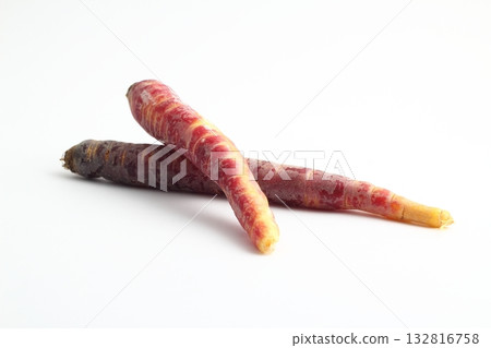 fresh black carrots on white background. isolated black carrots. 132816758