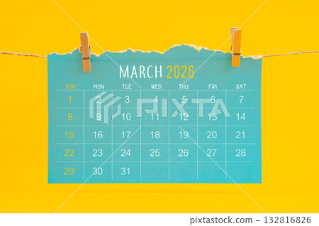March 2026 calendar tearing hanged with brown rope on yellow color background. March 2026 calendar tearing hanged with brown rope on yellow color background. 132816826