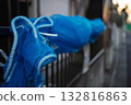 Blue windbreak netting wrapped around a residential fence Blue windbreak netting wrapped around a residential fence 132816863