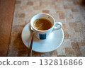 A cup of espresso with a spoon A cup of espresso with a spoon 132816866
