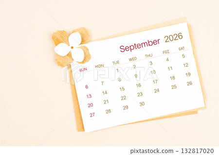 September 2026 calendar with origami flower paper on beige color background. September 2026 calendar with origami flower paper on beige color background. 132817020