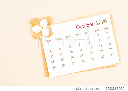 October 2026 calendar with origami flower paper on beige color background. October 2026 calendar with origami flower paper on beige color background. 132817021