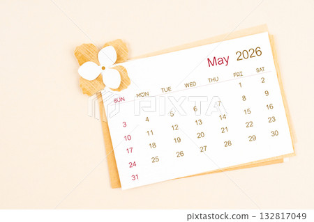 May 2026 calendar with origami flower paper on beige color background. May 2026 calendar with origami flower paper on beige color background. 132817049