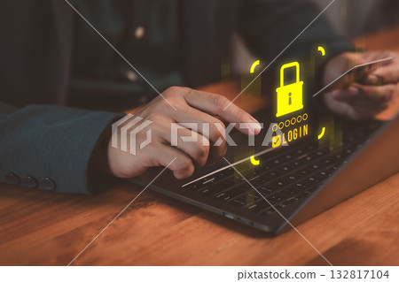 Person holding credit card and typing on laptop with shield and padlock icons, representing online payment protection, cybersecurity, business online, digital identity safety and secure transactions. 132817104