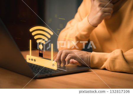 Cybersecurity and WiFi protection concept. WiFi router with a lock symbol appears above a laptop, representing secure internet connection, online privacy, network protection and safe browsing. 132817106