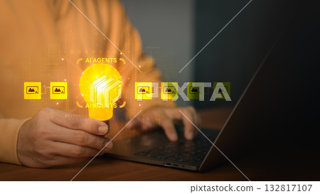 AI innovation and intelligent agents concept. A person working on a laptop holding a light bulb with digital AI icons, symbolizing artificial intelligence, automation, creativity and smart solutions. 132817107