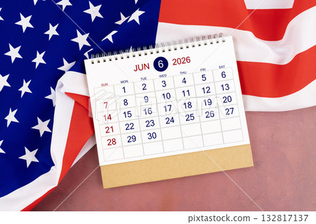 June 2026 Monthly desk calendar and United States of America flag. 132817137