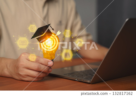 Creative light bulb with graduation cap and digital education icons, symbolizing knowledge, e-learning, innovation, online study, academic success and technology for global digital learning concepts. 132817162