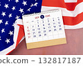 September 2026 Monthly desk calendar and United States of America flag. 132817187