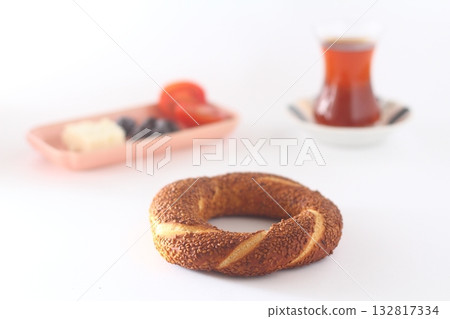Turkish bagel, simit, tomatoes & Turkish tea on white background. 132817334