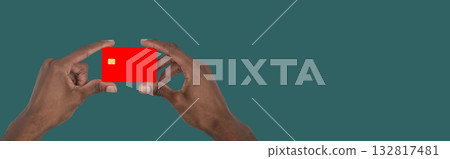 Hand holding bank card close up. African American male showing modern credit card concept for 132817481