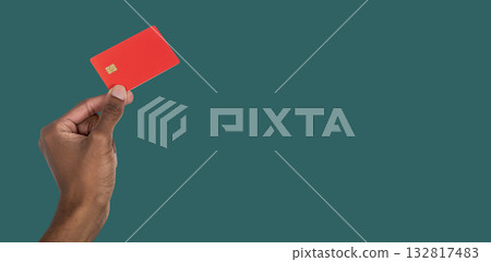 Hand holding bank card for online purchase. African American male showing modern credit or debit Hand holding bank card for online purchase. African American male showing modern credit or debit 132817483