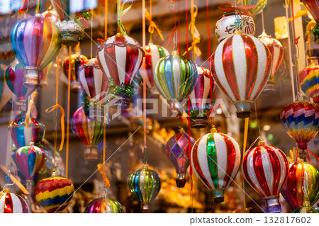 Christmas store window. Sale of Christmas ball in the form of air balls. Colorful glass toys for the Christmas tree. Decor 132817602
