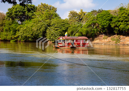 Non motorized ferry, called planchon, used by residents to cross the Sinu River from one bank to the other in the city of Monteria, Colombia. Non motorized ferry, called planchon, used by residents to cross the Sinu River from one bank to the other in the city of Monteria, Colombia. 132817755