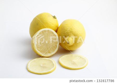 Ripe whole yellow lemon citrus fruit with lemon slice isolated on white background with clipping path. Ripe whole yellow lemon citrus fruit with lemon slice isolated on white background with clipping path. 132817786
