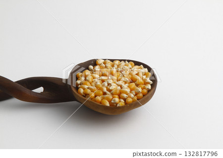 sweet corn in the wooden spoon an isolated on white background sweet corn in the wooden spoon an isolated on white background 132817796