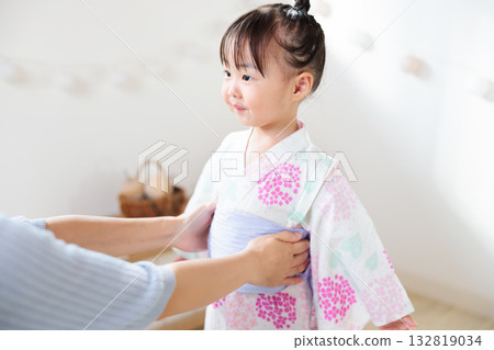 A 2-year-old girl wearing a yukata. Children's yukata dressing 132819034