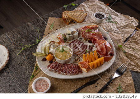 Charcuterie board featuring assorted cheeses Charcuterie board featuring assorted cheeses 132819149