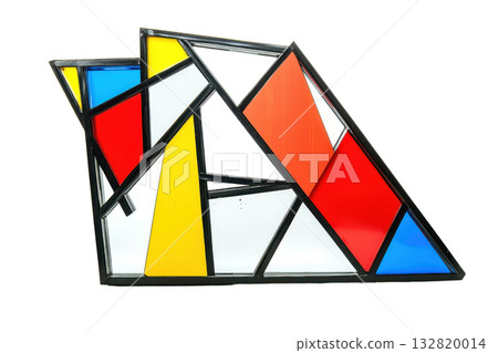A geometric arrangement of colored glass pieces, featuring vibrant red, yellow, blue, and white sections framed in black. 132820014