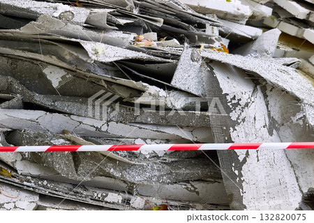 Construction debris.Old insulation material removed from walls.Fenced red tape 132820075