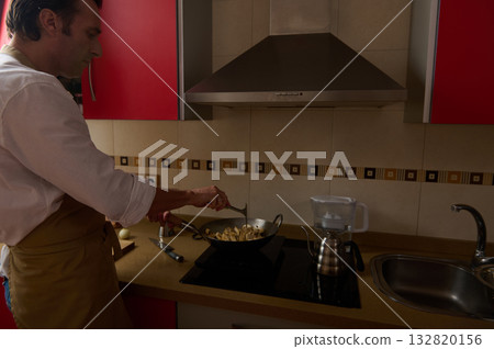 Father Cooking Dinner in Modern Kitchen While Child Helps Stir Pan Tonight For Family Together Father Cooking Dinner in Modern Kitchen While Child Helps Stir Pan Tonight For Family Together 132820156