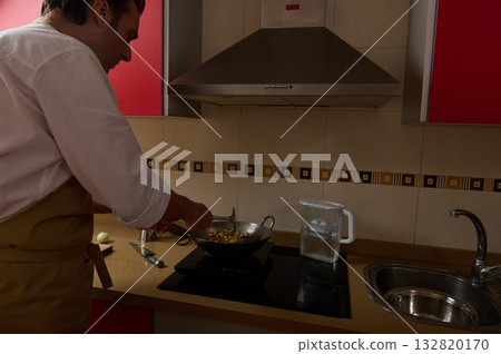 Father Cooking Dinner In Modern Kitchen While Little Girl Helps With Wok Stir Fry Father Cooking Dinner In Modern Kitchen While Little Girl Helps With Wok Stir Fry 132820170