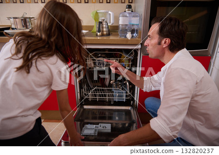 Father And Daughter In Kitchen Helping With Dishwasher Load After Dinner Father And Daughter In Kitchen Helping With Dishwasher Load After Dinner 132820237