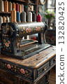 Classic retro style manual sewing machine ready for sewing work. The machine is old style made of metal with floral patterns 132820425