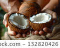 An open coconut in human hands. 132820426