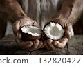 An open coconut in human hands. 132820427