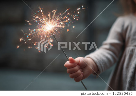 A child's small hand holding a sparkly magic wand, wide-eyed with belief in fantastical adventures and dreams. A child's small hand holding a sparkly magic wand, wide-eyed with belief in fantastical adventures and dreams. 132820485