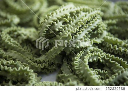 Fresh green pasta. Natural dyes. The pasta cooking process. Small pasta production. Fresh green pasta. Natural dyes. The pasta cooking process. Small pasta production. 132820586