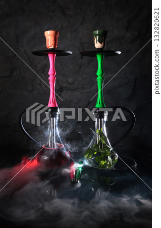 Two hookahs with mint and raspberries on a dark gray background. Hookah bar. For a weekend party or a holiday. 132820621
