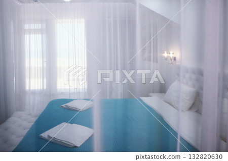 Four-poster bed. A cozy bedroom in bright colors. The concept of recreation. Four-poster bed. A cozy bedroom in bright colors. The concept of recreation. 132820630