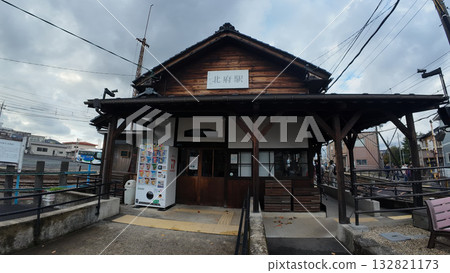 Contrast of Fukui Railway Kitafu Station: Retro station building and new low-floor train FUKURAM 132821173