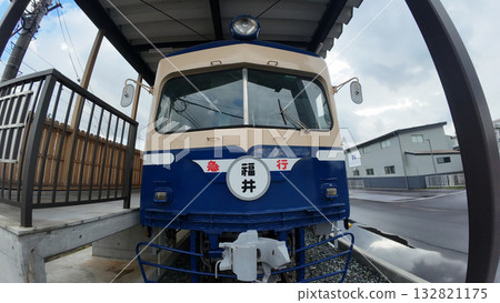 Contrast of Fukui Railway Kitafu Station: Retro station building and new low-floor train FUKURAM 132821175