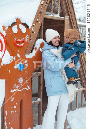 Mother and Child Enjoying Winter with Gingerbread Man 132821246